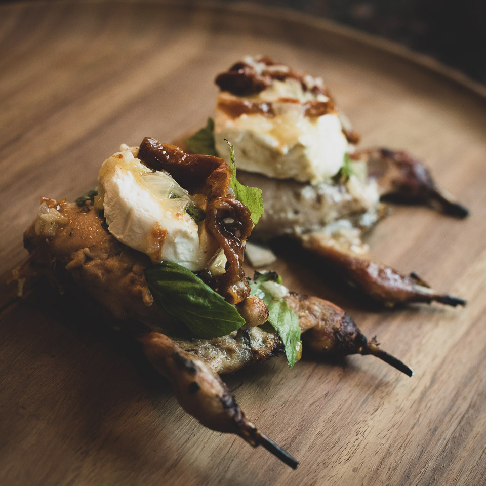 Wood-fired Quail with Sun-dried Tomatoes and  Goat Cheese in a White Wine Reduction Sauce